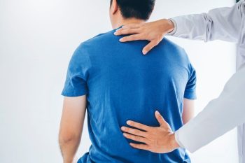 physical-doctor-consulting-with-patient-about-back-problems-physical-therapy_18497-1119